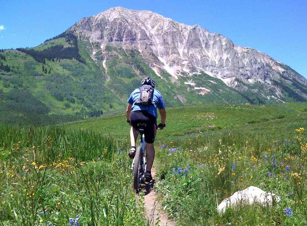 man biking at a grassy field at yosemite weather