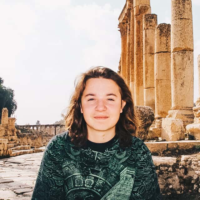 Young girl in front of ruins