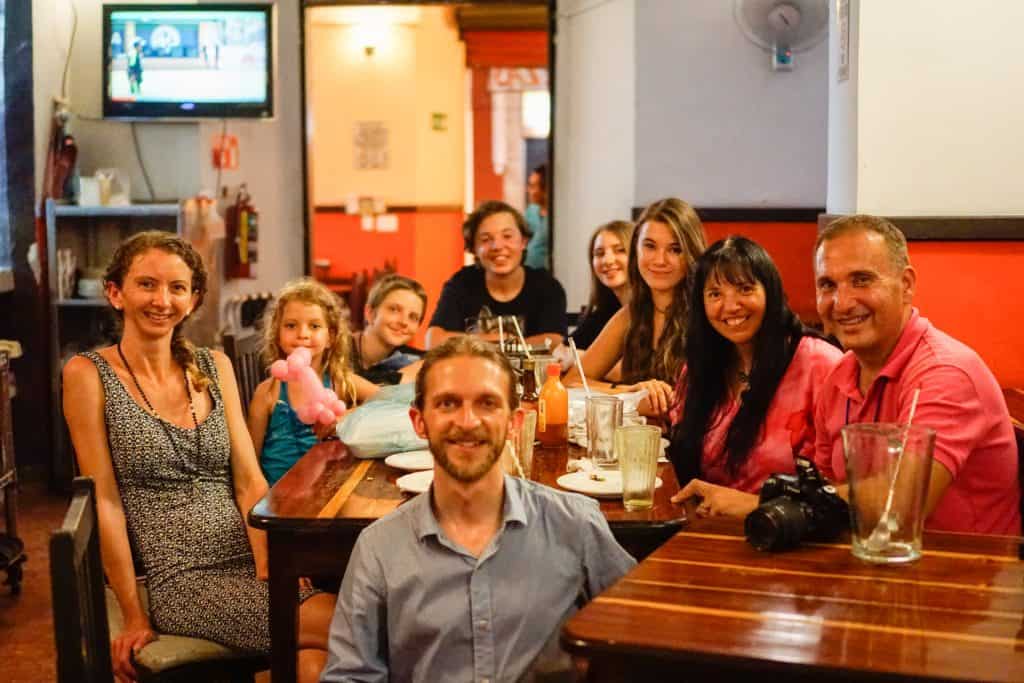 Family picture enjoying pizza in a restaurant