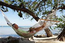 man relaxing on a hammock at the beach in Mexico
