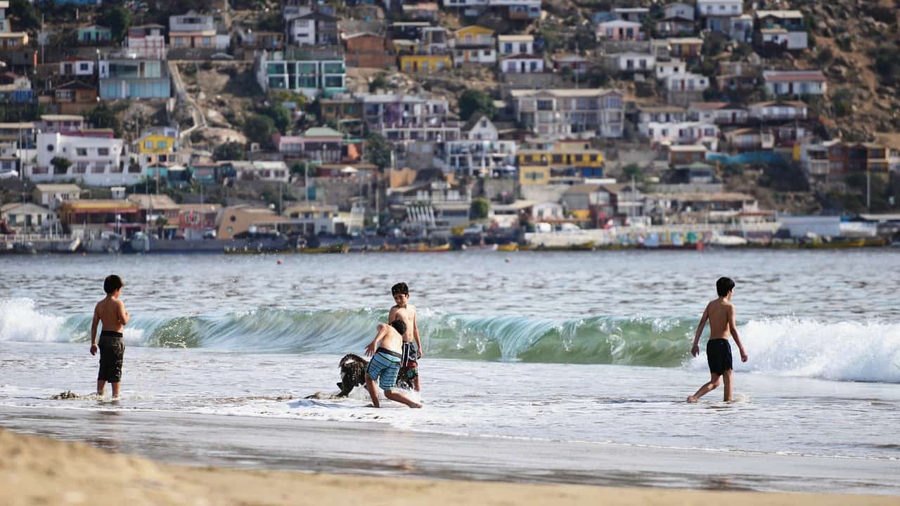 kids playing in the ocean in Chile