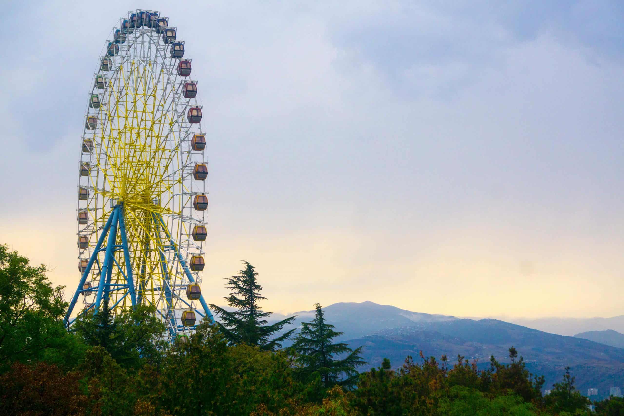 ferris wheel with mountains in the distance
