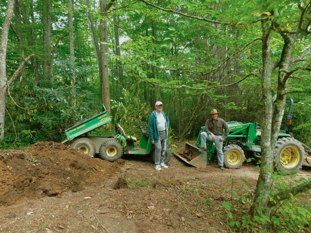 A friend helps Gary Scott expand his North Carolina ginseng patch.
