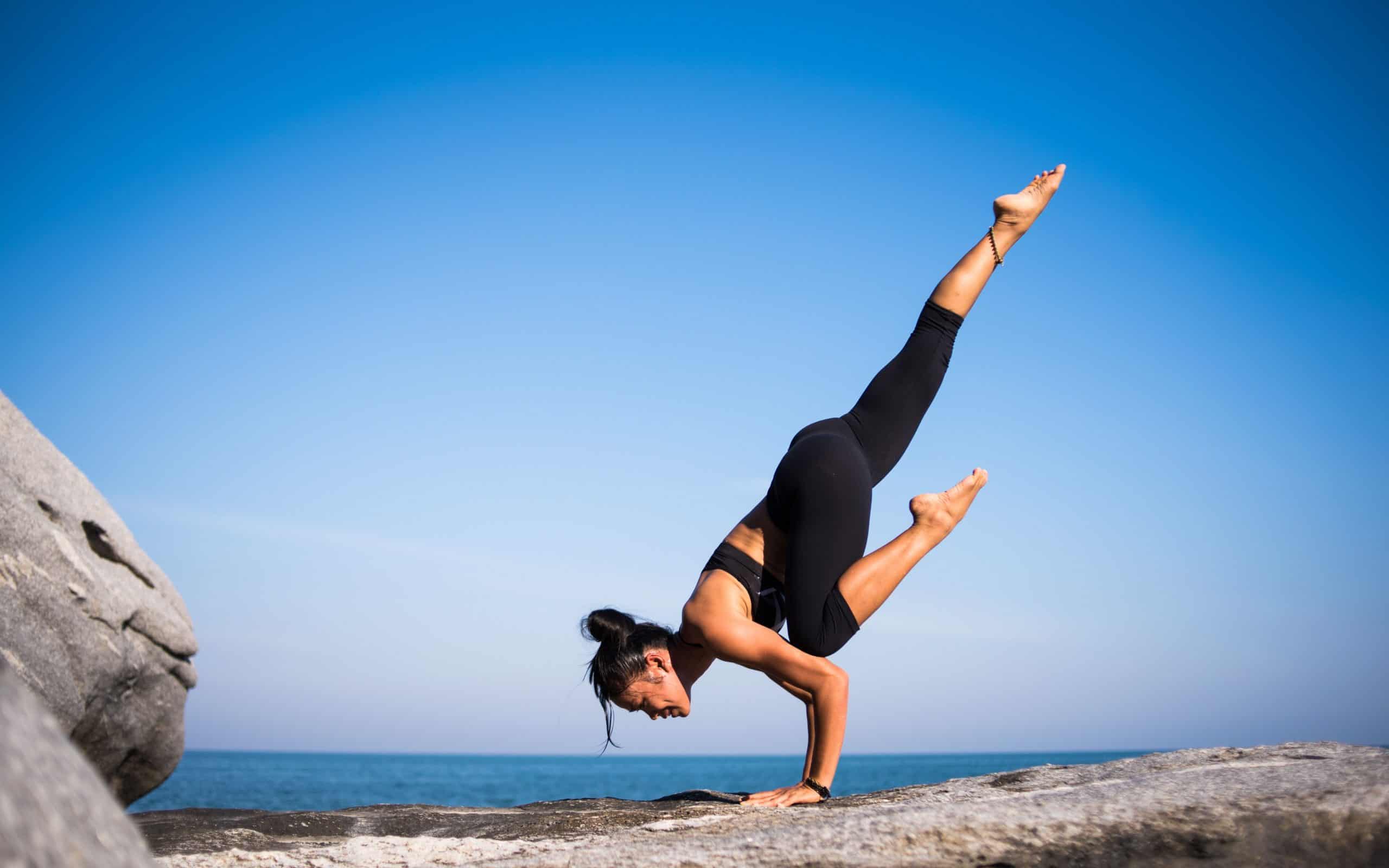 woman doing yoga on a mountain