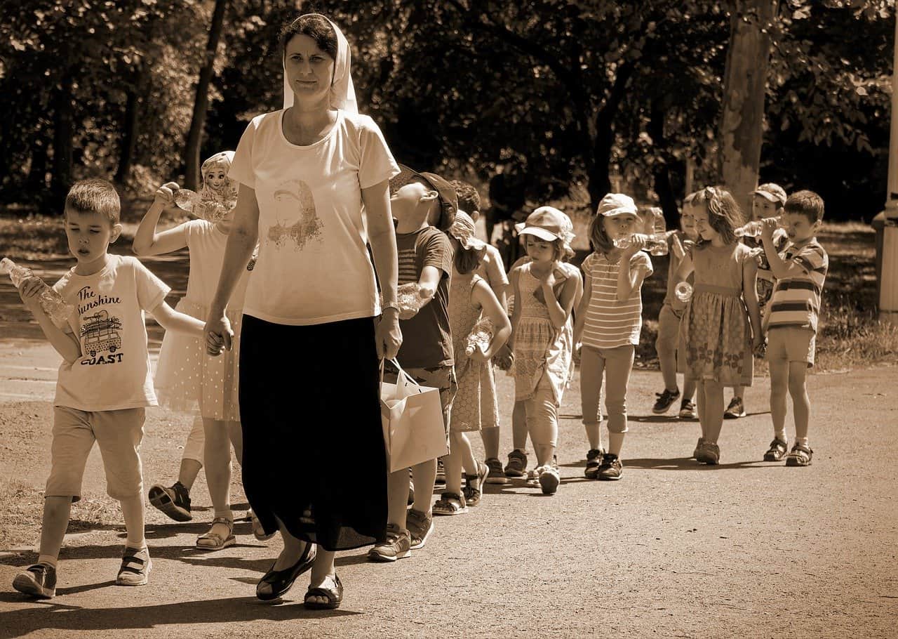 Teacher with her students walking outside