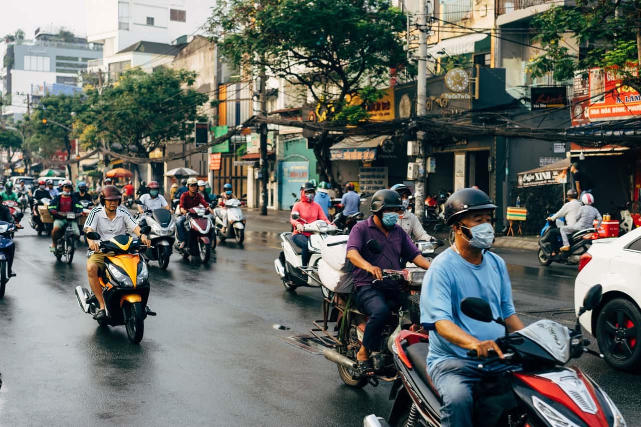 many people on bikes on the street