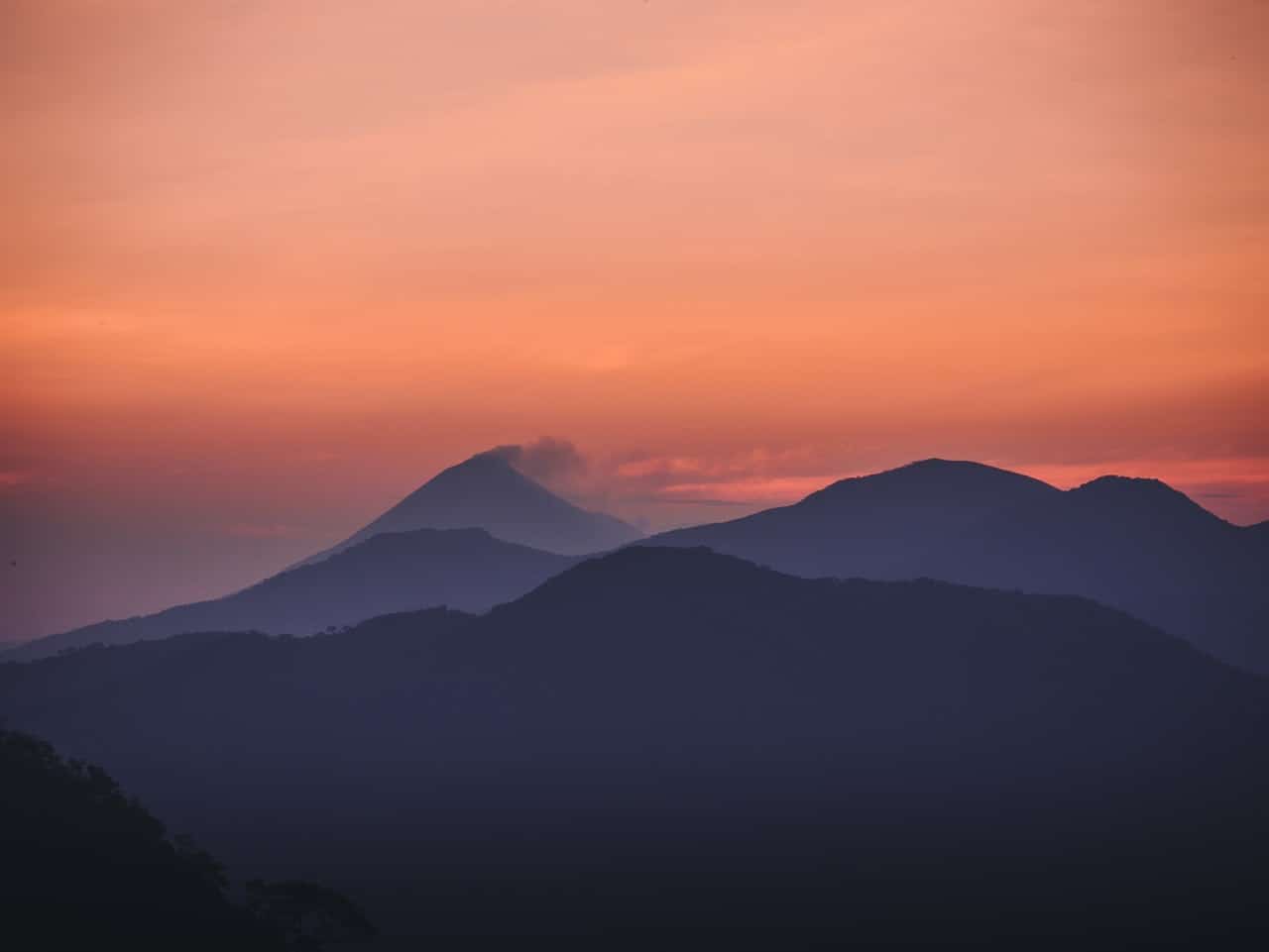 mountains beneath an orange sky