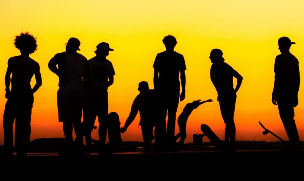 several boy silhouettes on skateboards