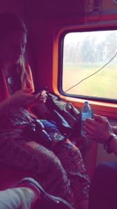 Gabby charging her phone hour 13 on our sleeper car, India, travel