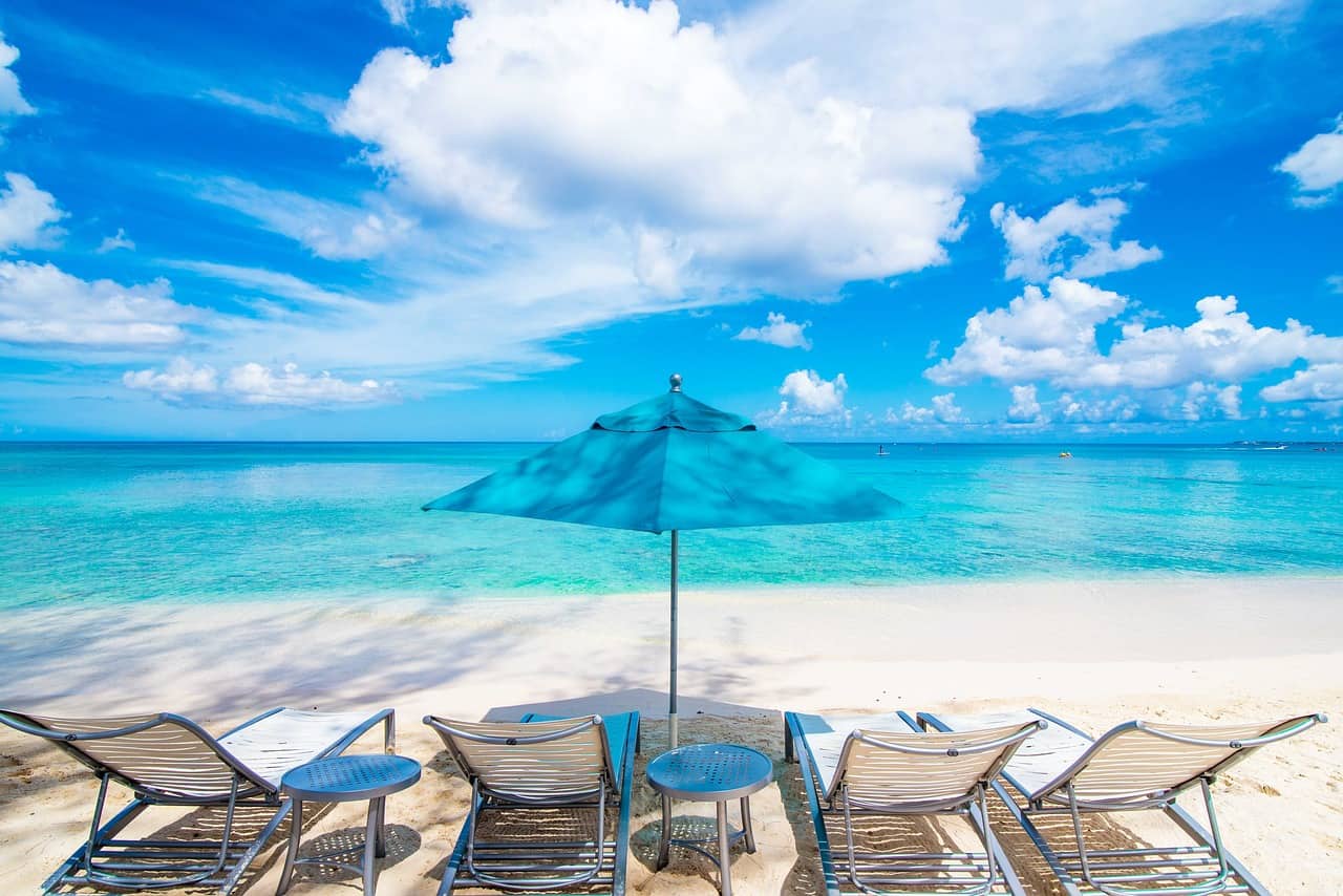 beach with blue umbrella at Cayman Island