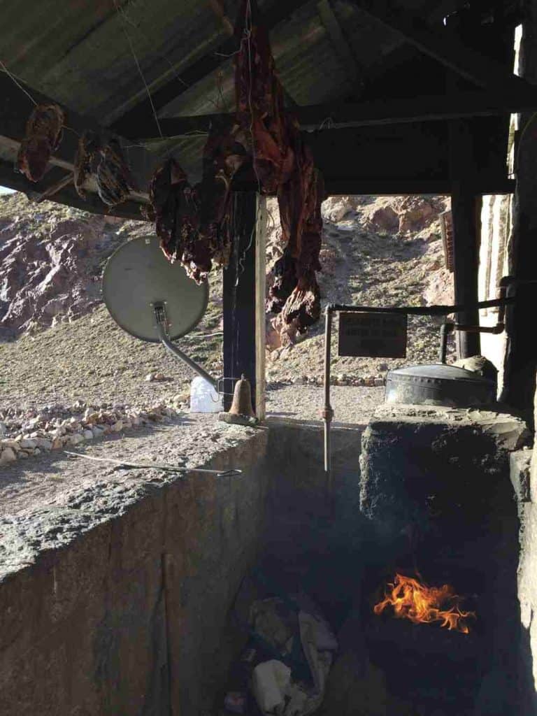 Wood stove drying meat and satelite dish