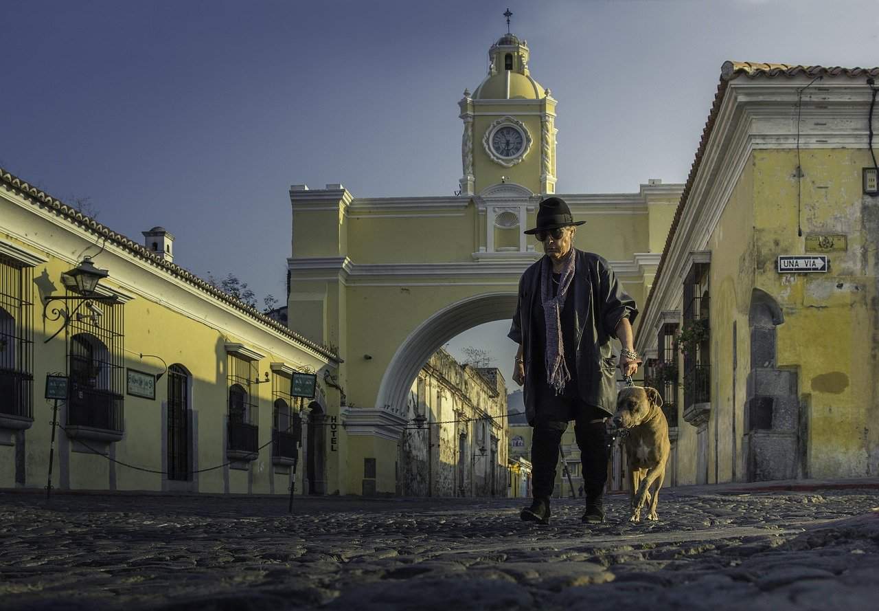 Man with his dog in a square in Guatemala