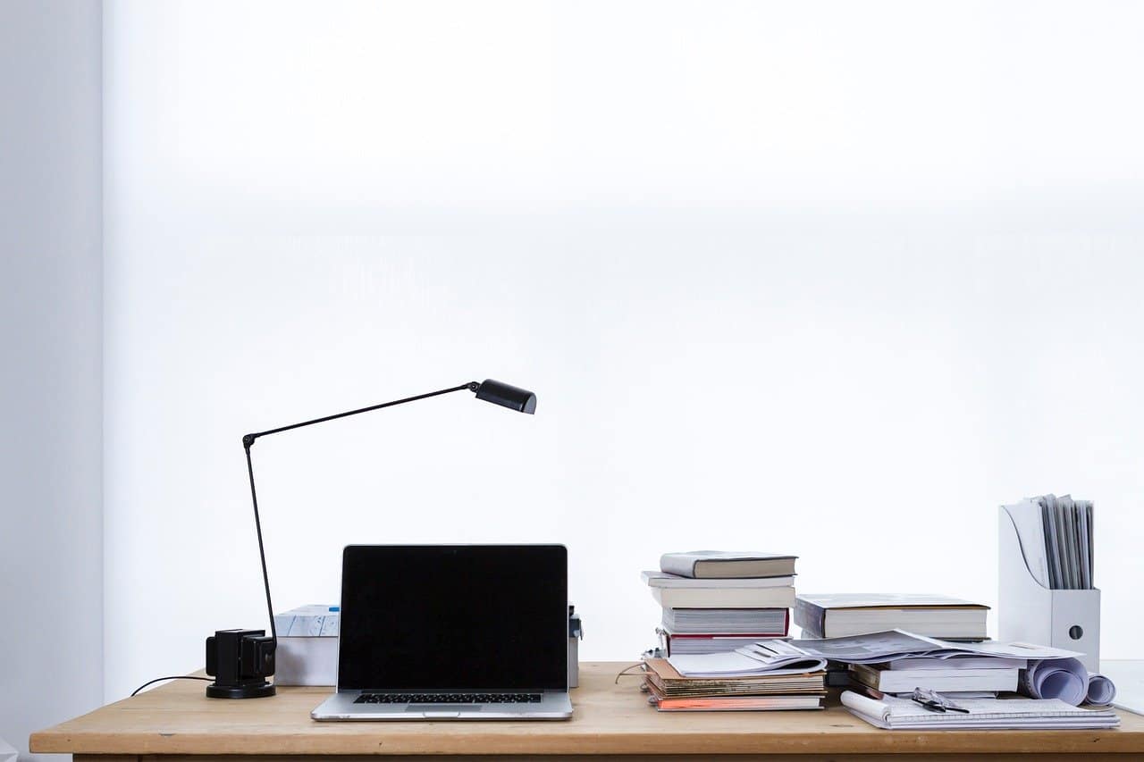 Laptop and books on desk