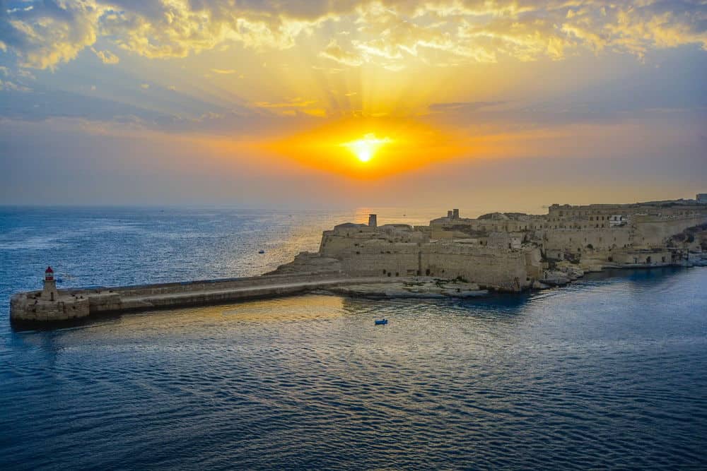 aerial view of an island with the sun above the horizon