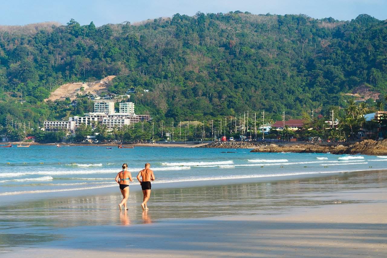 senior couple running on the beach