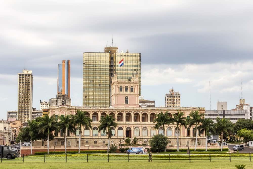 hude building with a garden in front of it