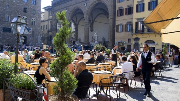 People having dinner outside in Italy in a cafe