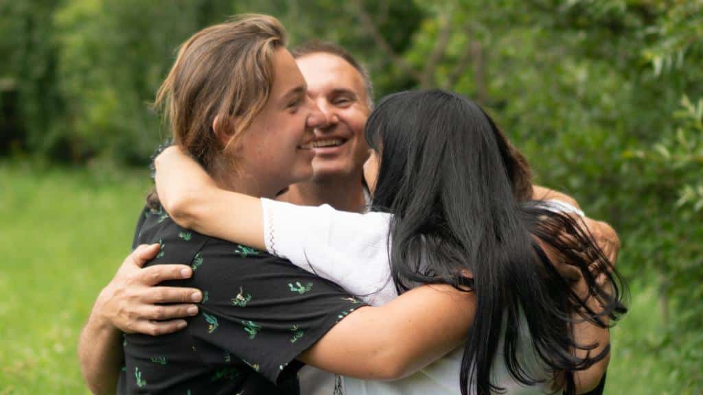 Three Adults hugging