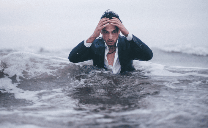 men with suit and white shirt inside the sea