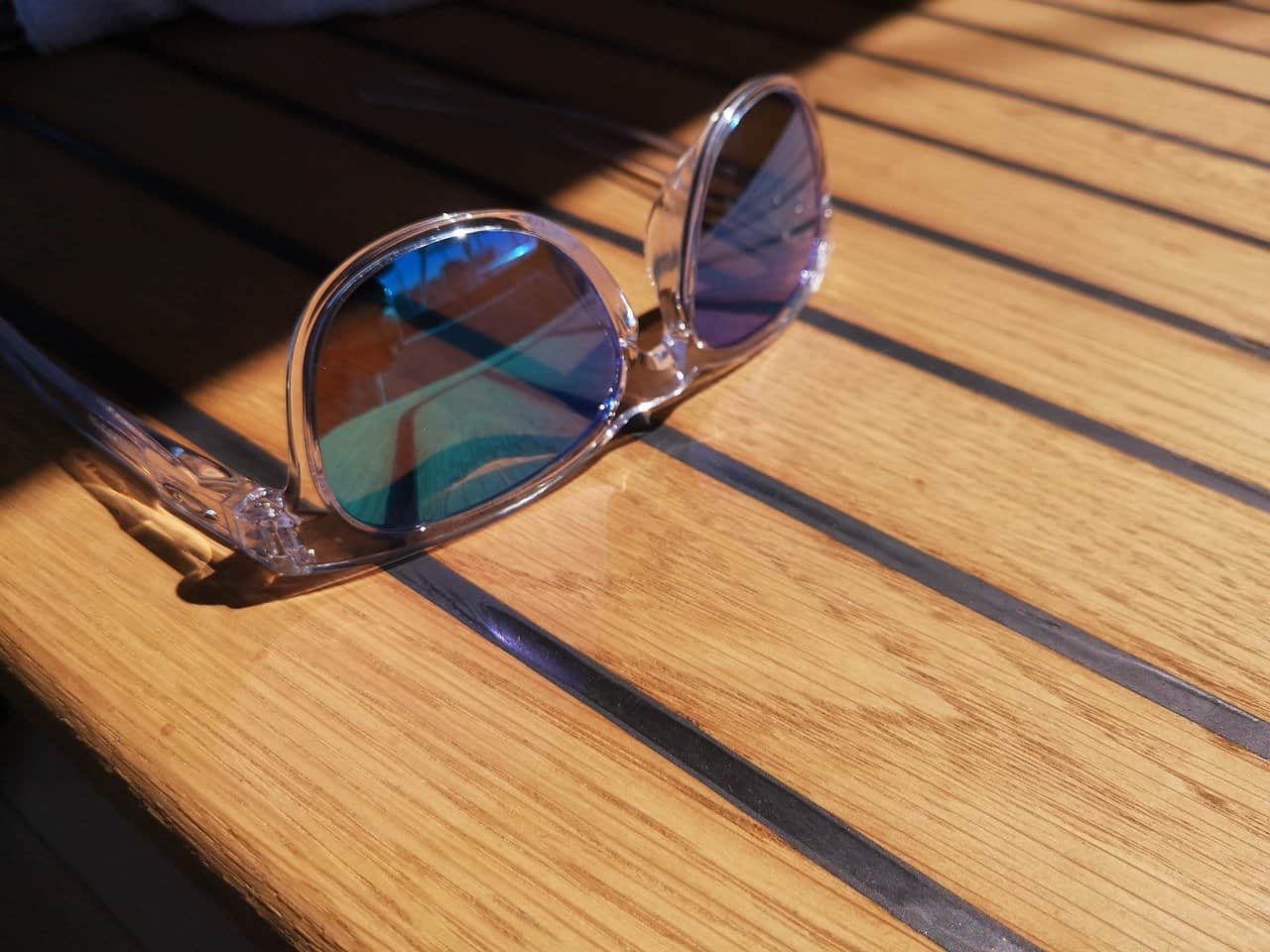sunglasses on a teak table