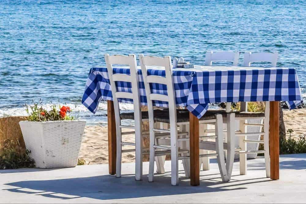 Table with cloth on it overlooking the sea in Greece