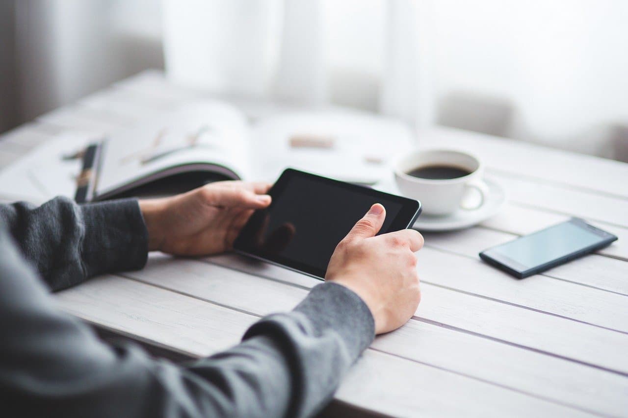 Man with technology and a coffee