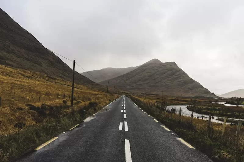 Winding rural roads meet rugged Irish coastlines.
