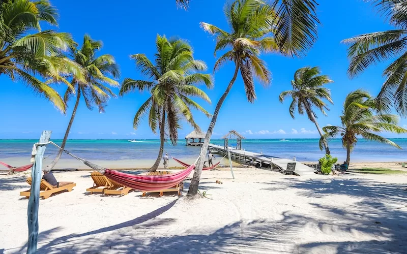 A bridge leads to a serene palapa in Ambergris Caye, Belize. 