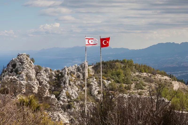 Turkish and Northern Cypriot flags fly side by side in Nicosia.