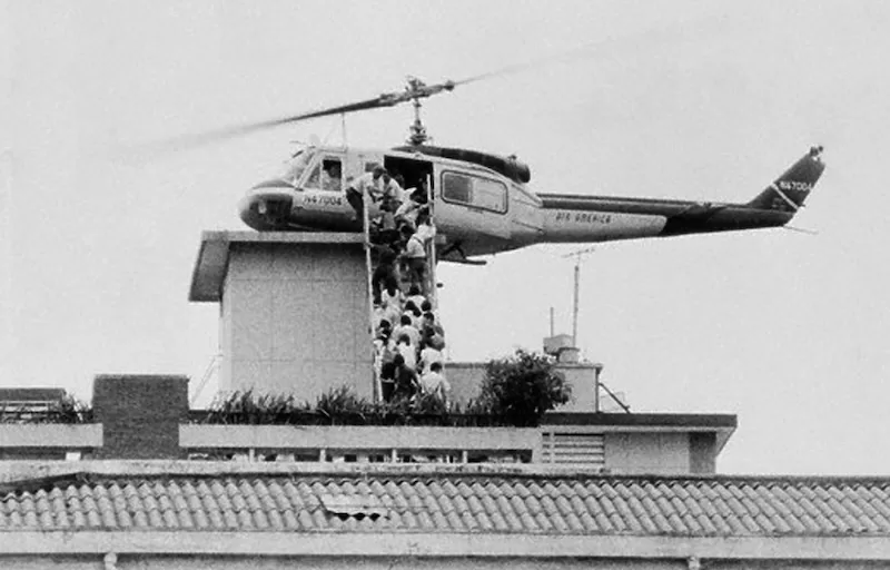 Vietnamese evacuees board an Air America helicopter in Saigon
