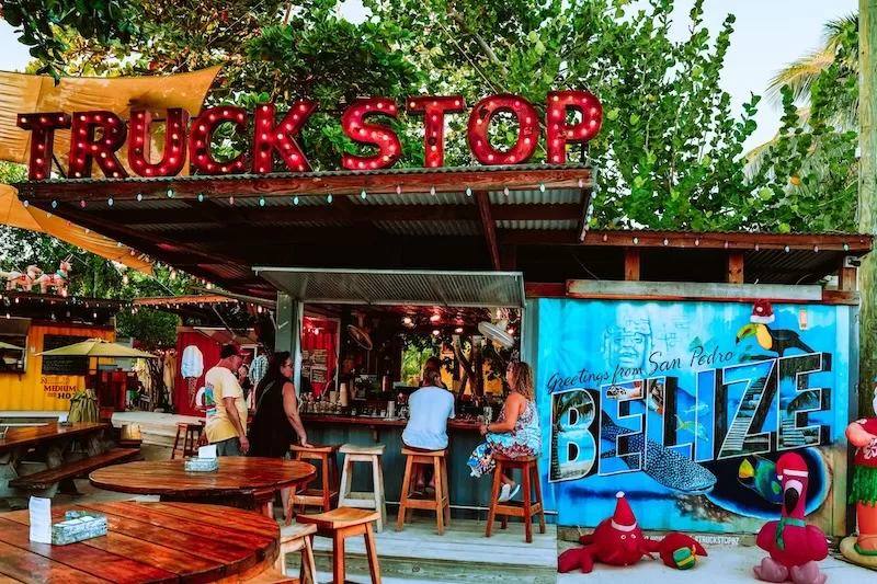 People chatting at The Truck Stop in San Pedro, Belize, a popular hangout among locals and expats.