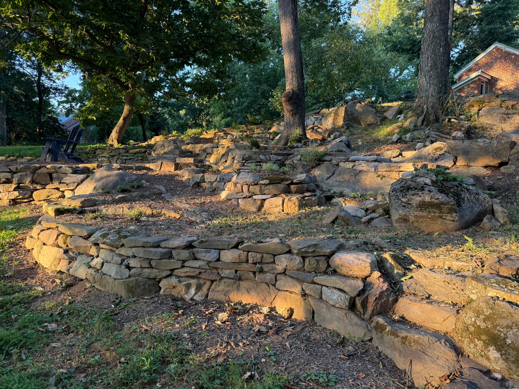 Dry stack irregular rock walls terracing Mike’s back yard. 