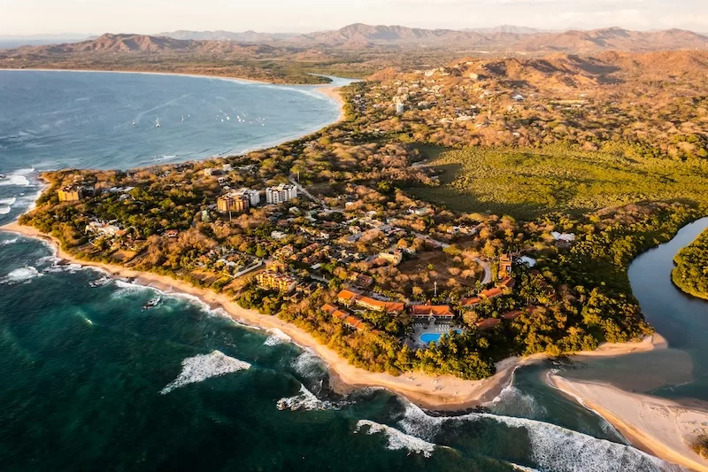 Golden-hour view of Tamarindo and the surrounding Gold Coast in Guanacaste, one of Costa Rica’s most desirable rental regions, where oceanfront villas and hillside homes offer world-class views, strong expat communities, and easy access to beaches, cafés, and year-round sunshine.