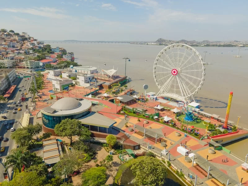 Guayaquil’s Malecón 2000 curves along the Guayas River, a vibrant mix of gardens, cafés, and riverfront views. The city’s essence is here, where commerce meets leisure, and the tropical air teems with energy and motion.