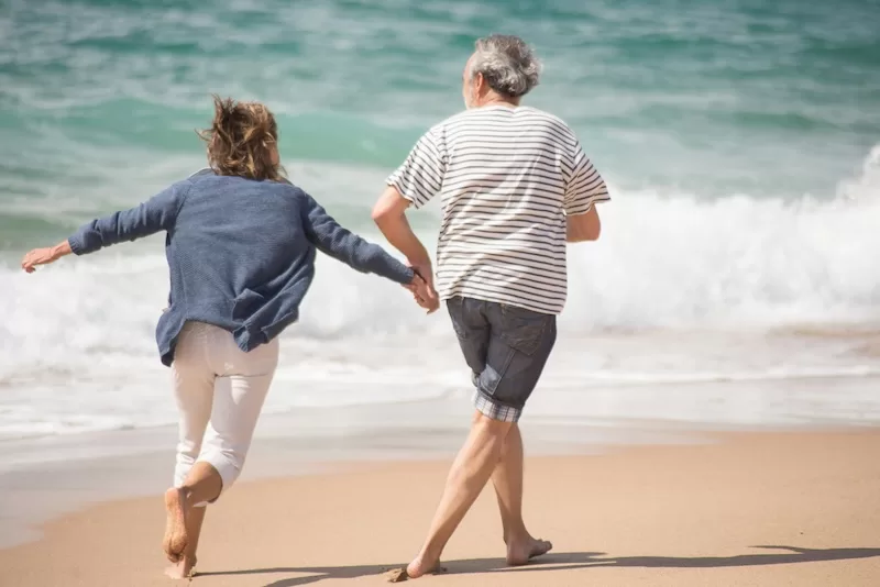 A couple runs along the Portuguese coast. With a stable economy, excellent healthcare, and access to the Schengen Zone, Portugal makes it easy to turn financial independence into a life rich in sunshine, community, and possibility.