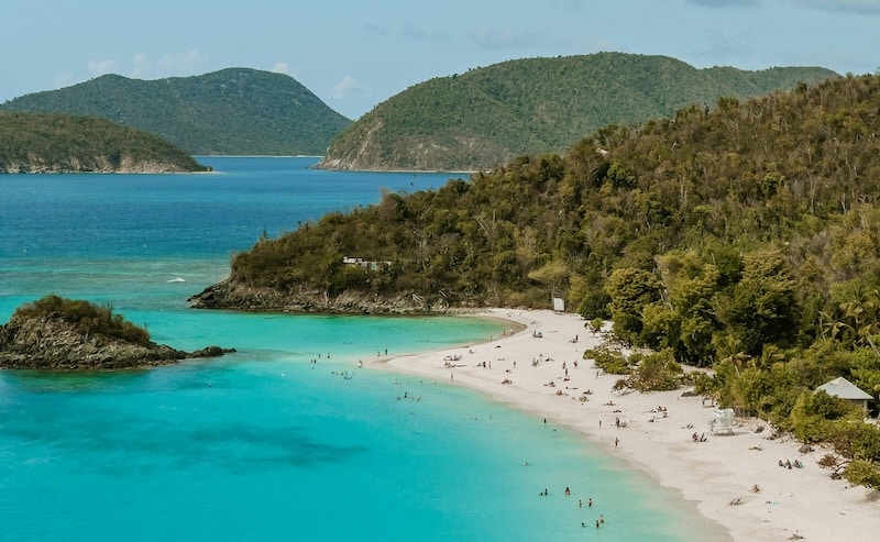 Trunk Bay on St. John, where forested hills meet calm turquoise water inside Virgin Islands National Park.