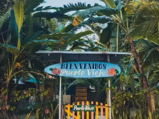 Welcome sign in Puerto Viejo de Talamanca, a laid-back Caribbean town that offers one of Costa Rica’s most colorful and affordable coastal lifestyles.