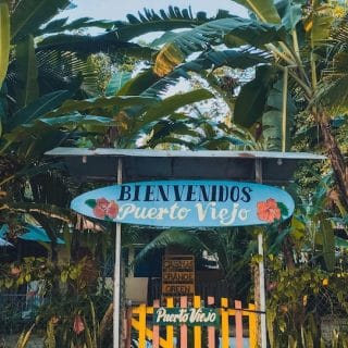 Welcome sign in Puerto Viejo de Talamanca, a laid-back Caribbean town that offers one of Costa Rica’s most colorful and affordable coastal lifestyles.