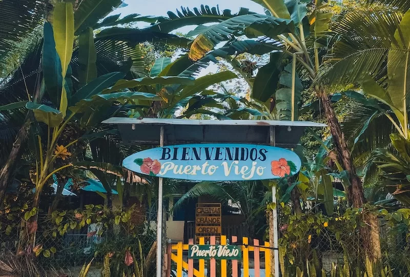 Welcome sign in Puerto Viejo de Talamanca, a laid-back Caribbean town that offers one of Costa Rica’s most colorful and affordable coastal lifestyles.