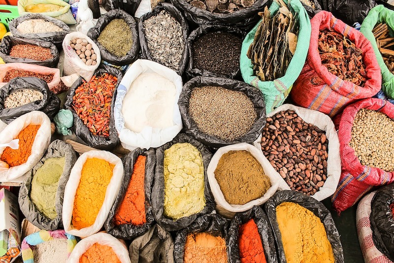 A rainbow of Ecuadorian spices at a local market. From ground achiote and turmeric to cacao and Andean herbs, every handful tells a story of trade routes, ancestry, and the flavors that define Ecuadorian kitchens.