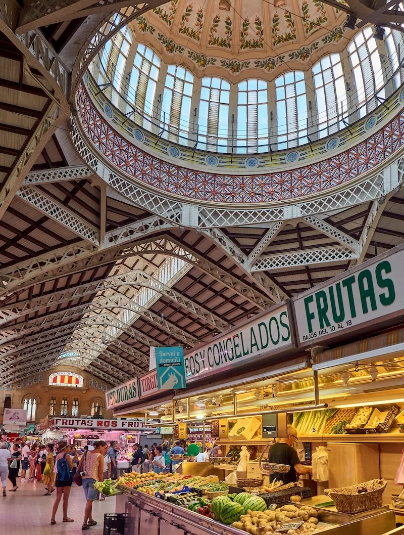 Inside Valencia’s Mercado Central, one of Spain’s iconic municipal markets, where locals shop for fresh produce, seafood, and bread at lower prices than supermarkets.