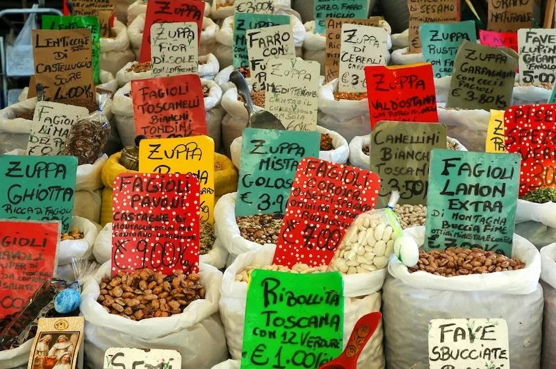 Italian markets turn grocery shopping into theater. Handwritten signs, family-run stalls, and vendors who throw in a little extra “for luck” make every purchase personal and often cheaper than the supermarket.
