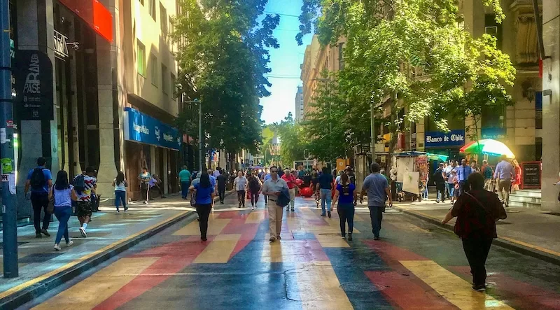 Beyond statistics, livability looks like this: people out walking, talking, and sharing the same sunlit street.
