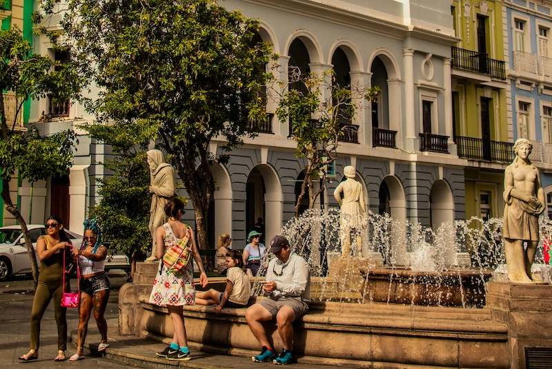 Warm weather turns public plazas into living rooms, giving retirees more motion, more sunlight and more community than any gym membership ever could.