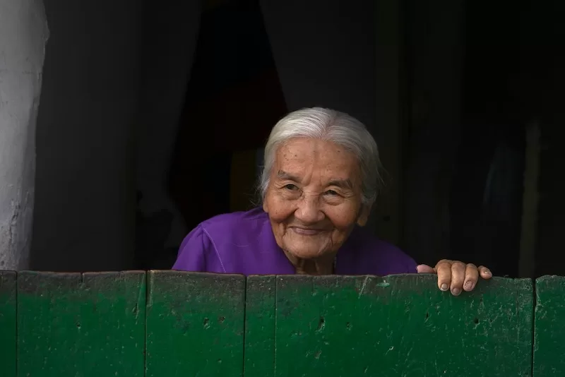 A grandmother in rural Colombia, her expression calm and knowing, reflects the deep respect given to elders across generations.