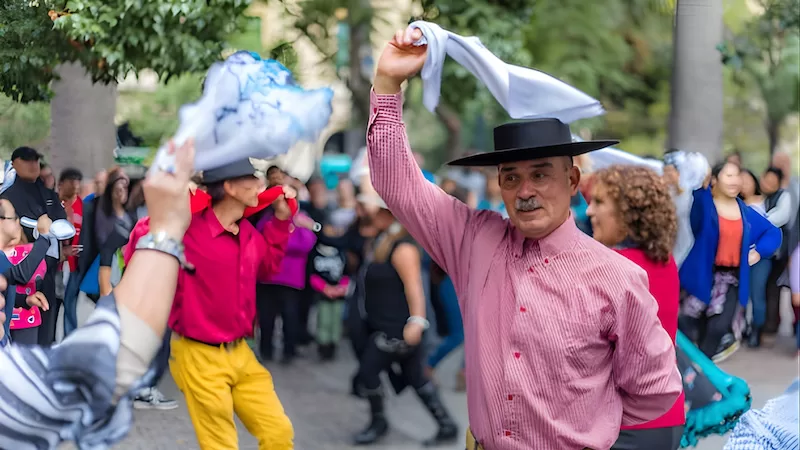 Handkerchiefs high, music carrying everyone along. Community coming alive one dance step at a time.