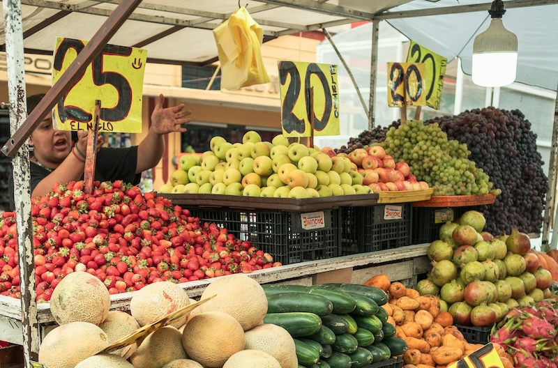 Fresh produce stalls in a local market, where fresh fruit, vegetables, and staples stay within reach for anyone budgeting carefully.