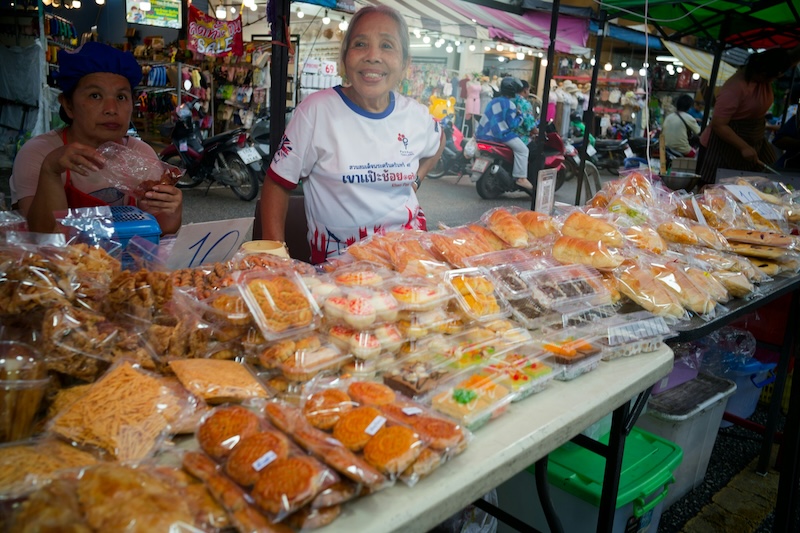Local markets turn affordability into abundance. Fresh pastries, snacks and home-cooked treats line the tables at prices marked with a simple handwritten sign. These everyday interactions — a smile from the vendor, a quick exchange of coins — show how living well in Thailand remains accessible.