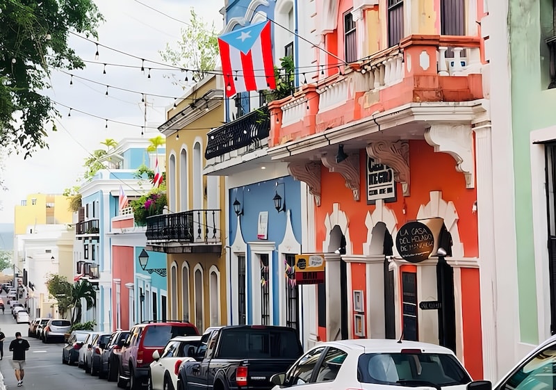 Pastel façades and wrought-iron balconies line Old San Juan, where heritage buildings now mix with modern investments and rising real estate demand.