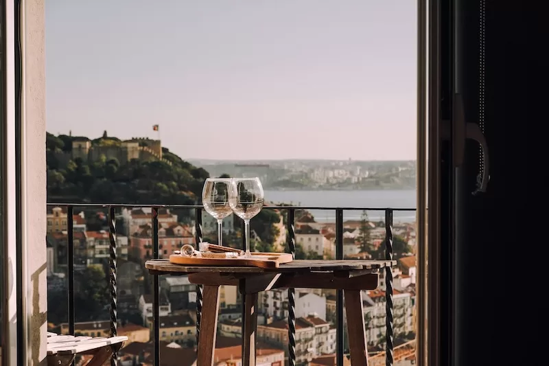 Wine glasses, a river breeze and time to enjoy both. In Lisbon, slowing down becomes part of the routine.